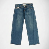 A pair of medium-wash blue denim Bubblegum jeans with silver-toned metal studs running down the outer seams of both legs, shown flat against a light gray background.