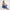 Lisa model sitting on the floor wearing a green tank top and a blue indigo Bubblegum Jeans on a white background