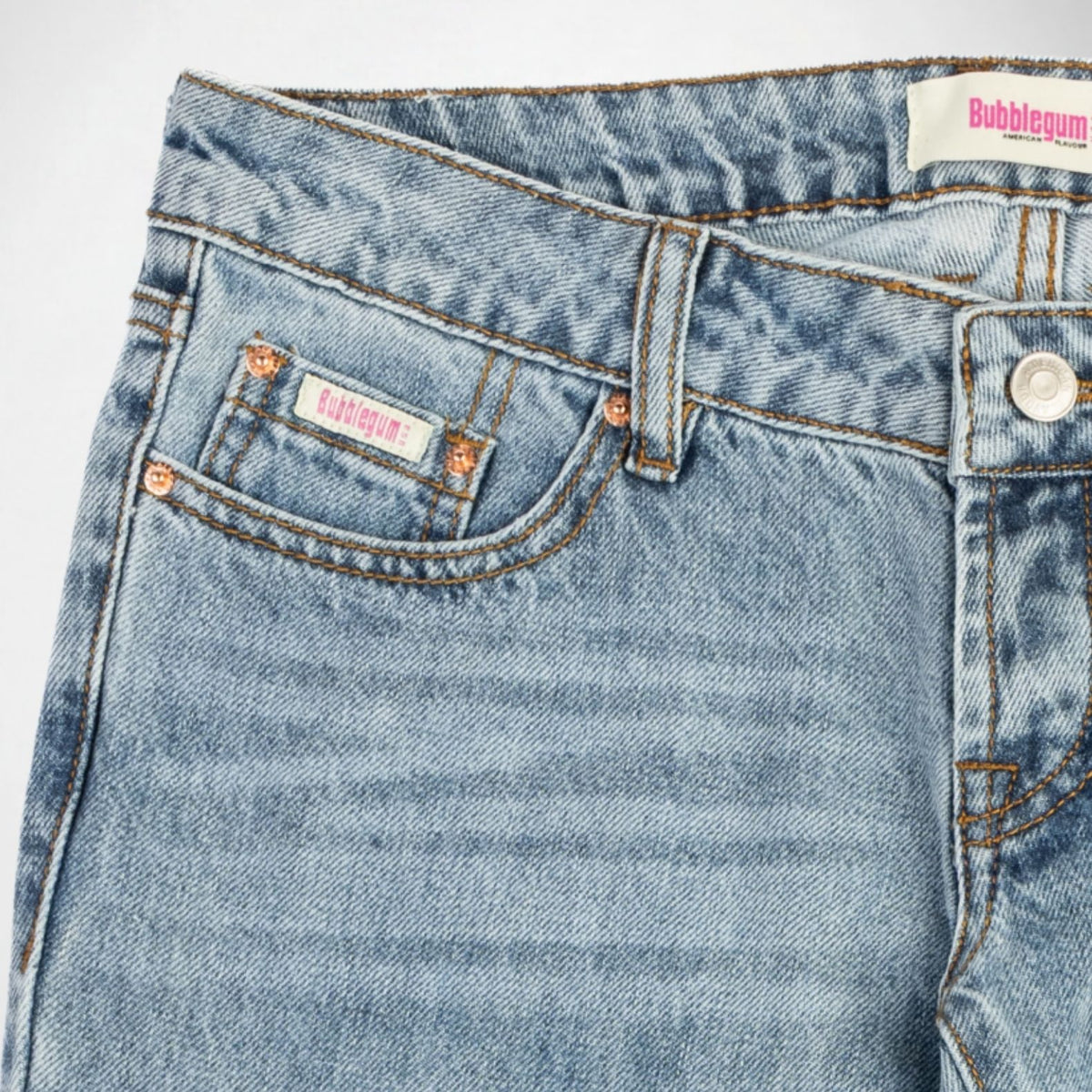 Close-up of a pair of light-wash blue denim Bubblegum jeans showing the waistband, belt loops, right pocket, and button. The fabric has a subtle vertical marbled or washed texture, and the brand name 'Bubblegum USA' is visible on the pocket label and waistband tag.