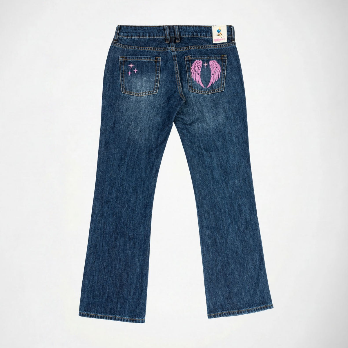 Back view of a pair of blue denim Bubblegum jeans with a pink embroidered angel wings design on the right back pocket and a small pink shining stars on the left back pocket, shown on a white background.
