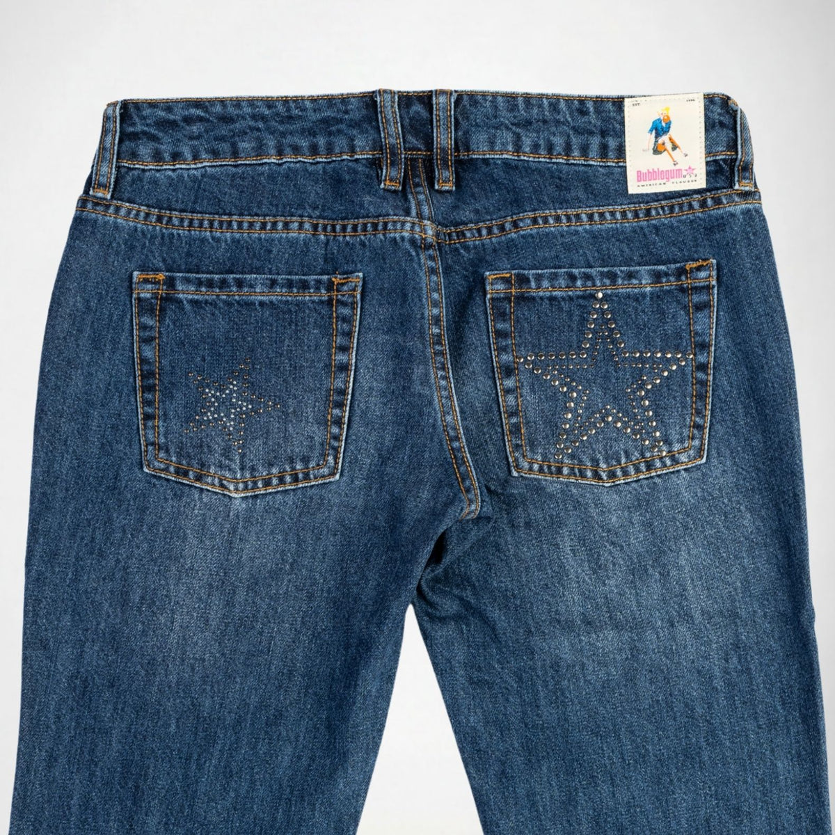 Back view of blue denim Bubblegum jeans featuring star-shaped stud embellishments on both rear pockets, shown against a plain white background.