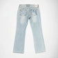 Light wash blue denim Bubblegum jeans shown from the back, featuring indigo and white cherry blossom flower embroidered details on the back pockets and a small colorful 'Bubblegum USA' brand label at the waistband, laid flat against a white background.