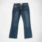A pair of dark blue denim Bubblegum jeans with a slight flare at the hem, exposed button look laid flat against a light gray background.