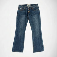 A pair of dark blue denim Bubblegum jeans with a slight flare at the hem, exposed button look laid flat against a light gray background.