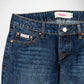 Close-up of a pair of dark blue denim Bubblegum jeans showing the waistband, front button closure, pocket details, and a visible 'Bubblegum USA' brand label.