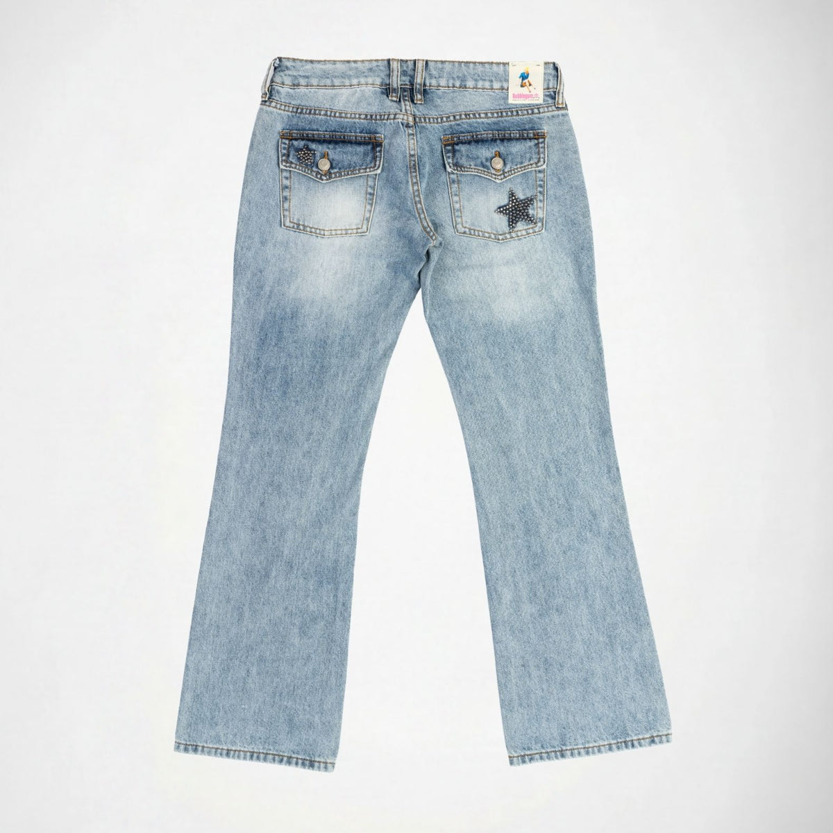 Back view of light-wash blue denim Bubblegum jeans with a star-shapped studs embellishment on the right and left back pockets, shown flat against a white background.