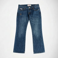 A pair of medium-wash blue Bubblegum denim jeans with a small silver star embellishment on the left hip, displayed flat against a plain white background.