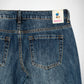 Close-up back view of blue denim Bubblegum jeans showing the waistband, belt loops, back pockets, and a visible Bubblegum USA label.
