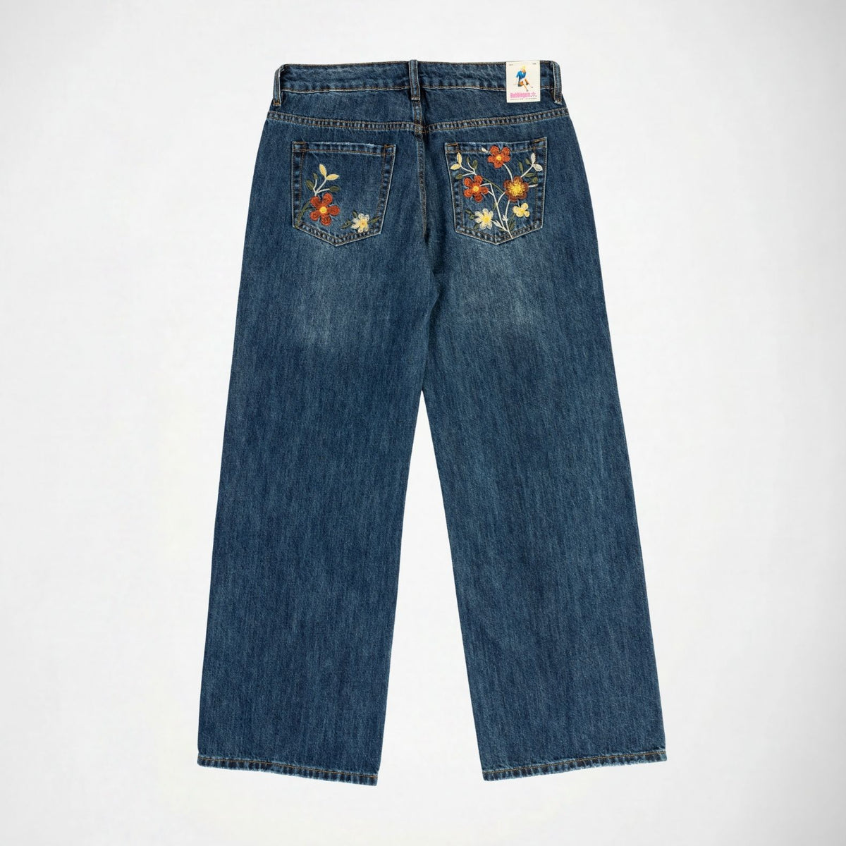 The Lisa low baggy wide in mid rise, wide leg fit in indigo vintage wash denim Bubblegum jeans with flower embroidery in both back pockets, with Bubblegum USA label on a white background
