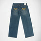Back view of a pair of blue denim Bubblegum jeans with gold thread embroidered winged heart with rhinestones on both back pockets, displayed flat against a white background.