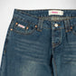 Close-up of a pair of blue denim Bubblegum jeans showing the front waistband, double belt loops, button closure, and front pockets with copper-toned rivets and contrast stitching. A visible label reads Bubblegum USA.