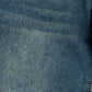 A close-up of blue denim fabric showing the woven texture and subtle fading.