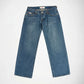 A pair of medium wash blue denim Bubblegum jeans laid flat against a light gray background.
