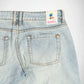 Close-up of the back waistband and rear pockets of light-wash blue denim Bubblegum jeans, showing a visible 'Bubblegum USA' brand label on the back waist.