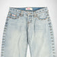 Light wash blue denim Bubblegum jeans with silver metal studs running down the outer seams of the legs, shown against a plain white background.