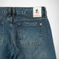 Close-up back view of blue denim Bubblegum jeans showing the waistband, belt loops, back pockets, and a visible Bubblegum USA brand patch.