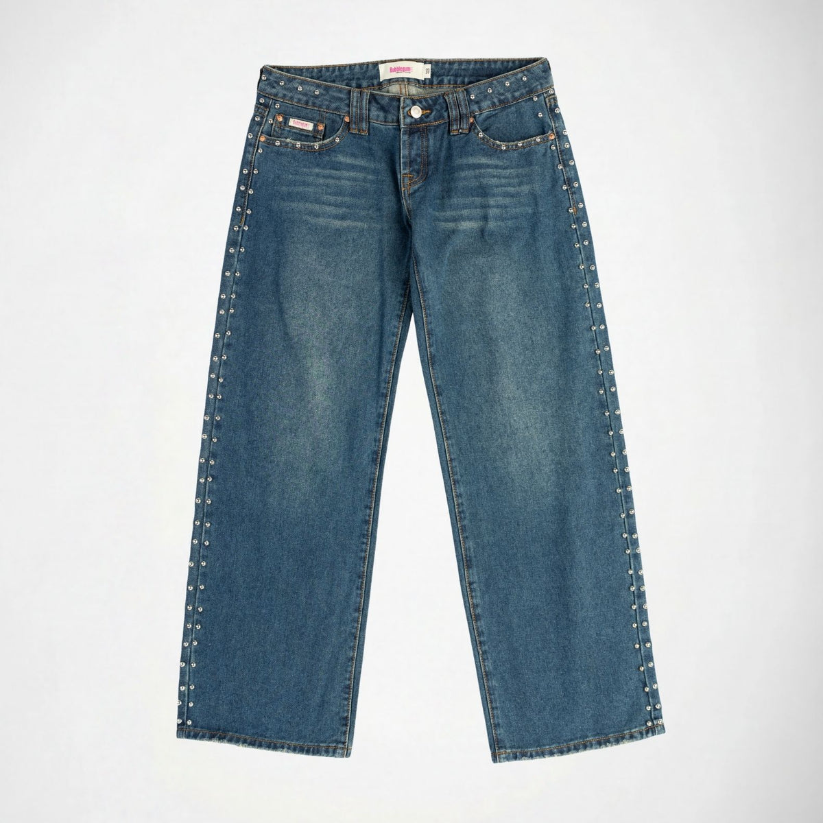 A pair of medium-wash blue denim Bubblegum jeans with silver-toned metal studs running down the outer seams of both legs, shown flat against a light gray background.