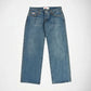 A pair of medium-wash blue denim Bubblegum jeans with decorative gold-tone metal studs running down the outer seams of both legs, shown flat against a light gray background.