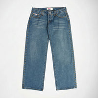 A pair of medium-wash blue denim Bubblegum jeans with decorative gold-tone metal studs running down the outer seams of both legs, shown flat against a light gray background.