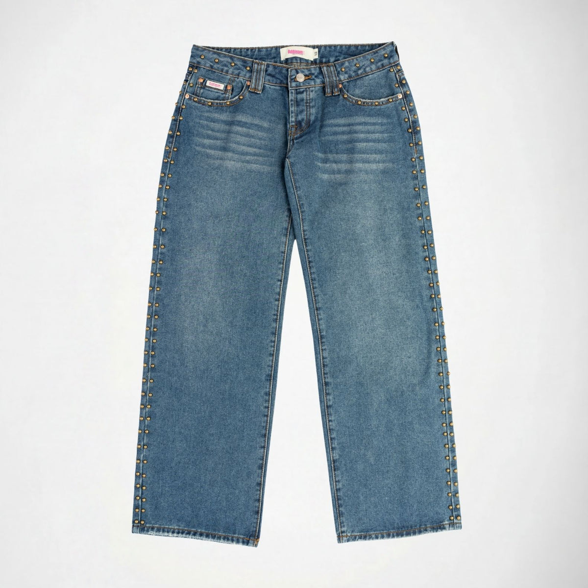 A pair of medium-wash blue denim Bubblegum jeans with decorative gold-tone metal studs running down the outer seams of both legs, shown flat against a light gray background.